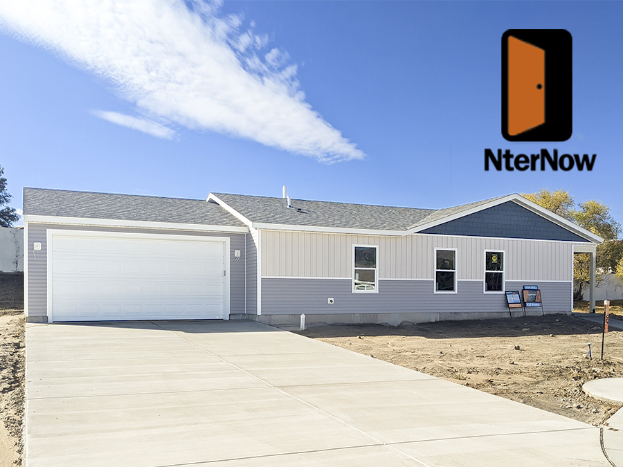 Ranch Style Tan white and blue new home with two car garage and farmhouse style exterior by Smart Dwellings